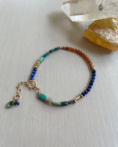 "Join my mailing list: http://eepurl.com/ci4wL and receive 10% off your next order! Find more of my jewelry on Instagram: Instagram: http://instagram.com/ruthiebeeeeee_jewelry Overview * Delicate turquoise, lapis lazuli, and hessonite garnet bracelet on durable nylon cord * Blue and orange bracelet * Natural stones and recycled brass accents * Layer with other bracelets or wear alone * Bracelet is adjustable * Finished with a gold-filled spring clasp and a tiny hand-wrapped bead and charm * Great for layering or wearing alone * Gift for her Details * * Available in the following sizes: XS (5.5-6\"), S (6-6.5\"), M (6.5-7\") L(7-7.5\") XL (7.5-8\") * Bracelet has a .5\" gold-filled extender and is adjustable ›› ›› ›› ›› ›› ›› ›› ›› ›› ›› ›› ›› ›› ›› ›› ›› ›› ›› ›› ›› ›› ›› ›› ›› ›› ›› ›› ›› Bohemian Blue Gemstone Bracelets, Blue Bohemian Gemstone Bracelets, Bohemian Blue Beaded Bracelets With Gemstone, Bohemian Blue Bracelets With Natural Stones, Bohemian Blue Bracelet With Natural Stones, Bohemian Blue Bracelets For Everyday, Blue Gemstone Beads Bracelet For Everyday, Blue Gemstone Bracelets For Everyday Wear, Everyday Blue Beaded Bracelet With Natural Stones