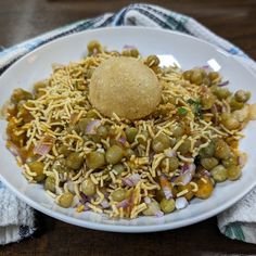 a white plate topped with lots of food on top of a blue and white towel