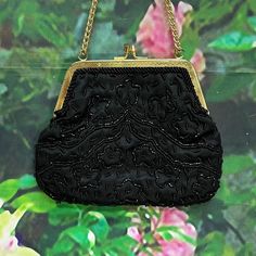 "Vintage lightweight evening purse from the 1970's made in Hong Kong by Richere. Black satin handbag has a floral design in small black glass beads. Gold tone engraved frame and kiss closure with double wrist chain. Interior is black satin with one pocket. Purse measures 7\" by 5\". Clean condition inside and out. Please see photos for more details. All items are vintage that are preowned. All of the items may show some form of wear due to their age. Please kindly remember that these items are a Satin Handbag, Cave Creek Az, Wrist Chain, Cave Creek, Purple Party, Evening Handbag, Evening Purse, Beaded Purses, Black Glass