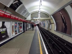 a subway station with people waiting for the train