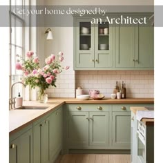 a kitchen with green cabinets and pink flowers