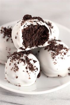 chocolate cake truffles with white frosting on a plate