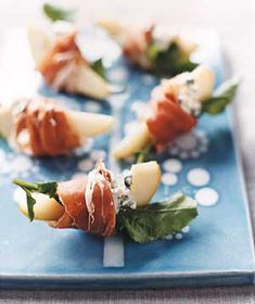 small appetizers are arranged on a blue plate