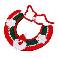 a crocheted christmas wreath ornament with santa claus and snowflakes