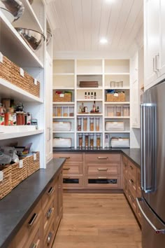 an organized kitchen with wooden cabinets and stainless steel appliances, along with lots of storage space