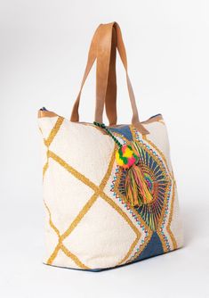 A bag worthy of a vacation! This bohemian oversize weekender bag features a colorful embroidered sunburst detail and suede leather trim. The large carry-all size is perfect for weekend getaways. Embroidered Stitch details Oversize tassel accent Zip-top closure Back exterior zip pocket Leather strap handles Bohemian weekender bag Dimensions: 24" X 17 3/4"Style: DR-8369 Embroidered Bucket Shoulder Bag For Travel, Embroidered Shoulder Bucket Bag For Travel, Travel Satchel With Embroidered Double Handle, Beach Tote Bag With Leather Trim, Beach Tote Shoulder Bag With Leather Trim, Leather Trim Tote Shoulder Bag For Beach, Embroidered Rectangular Bucket Bag For Travel, Bohemian Tote Shoulder Bag With Leather Trim, Bohemian Canvas Bag With Leather Handles For Travel