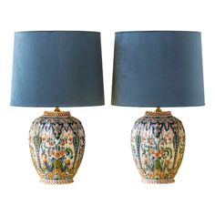 two blue lamps sitting next to each other