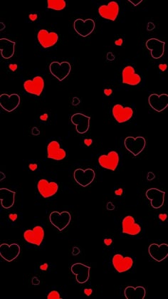 many red hearts floating in the air on a black background with space for your text