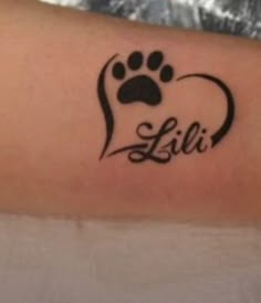 a person with a tattoo on their arm that has a dog's paw in the shape of a heart