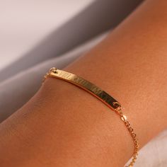 "This engraved bracelet features Roman numerals, adding a touch of personalization and elegance. Crafted with care, it's the perfect gift choice for her, reflecting both your thoughtfulness and the sentiment behind the date. Embrace the beauty of personalized jewelry and make her feel cherished with our Personalized Roman Numeral Bracelet, a meaningful and stylish accessory that she'll love to wear and treasure. #YOU MAY LIKE THIS silver bar cotton bracelet https://www.etsy.com/listing/149277659 Yellow Gold Bracelet With Engraving Option, Gold Charm Bracelet Gift, Adjustable Elegant Bracelet With Engraved Text, Adjustable Elegant Bracelets With Engraved Text, Personalized Yellow Gold Rectangular Name Bracelet, Personalized Rectangular Yellow Gold Name Bracelet, Elegant Charm Bracelet With Engraving Option, Elegant Engraved Adjustable Name Bracelet, Elegant Adjustable Name Bracelet With Engraved Text