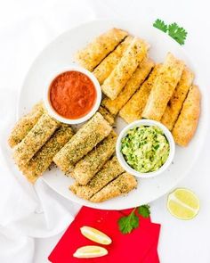 the plate is full of fried food with dipping sauces on it and garnished with cilantro