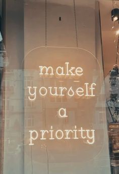 a sign that says make yourself priority on the glass window in front of a store