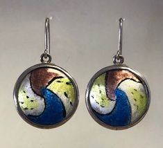 "Handmade one of a kind enamel and silver earrings. This set is fabricated from Argentium (anti-tarnish) sterling silver. They are each set with a free hand painted enamel to create a unique style. The enamel inserts are high fire vitreous enamel on fine silver. They are 1.375\" long by 7/8\" wide. They are hallmarked on the back. They have generous length 20ga (0.032\") ear wires and include silicon rubber retainers to keep them safe." Nickel-free Enamel Drop Earrings, Nickel Free Enamel Dangle Earrings, Enamel Dangle Jewelry With Matching Earrings, Enamel Dangle Earrings With Matching Jewelry, Handmade Enamel Dangle Jewelry, Green Enamel Earrings With Artistic Design, Multicolor Enamel Jewelry With Black Details, Multicolor Hand Painted Metal Jewelry, Hand Painted Multicolor Metal Jewelry