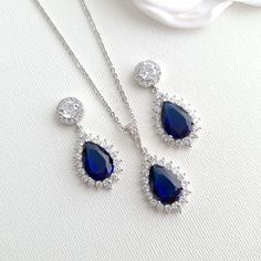 Sapphire Blue Stone Earrings, Bracelet, Necklace Set Made of Cubic Zirconia for Weddings If you are looking for matching earrings, necklace bracelet set in blue color, this sapphire blue store jewelry set with matching earrings, necklace, and adjustable bracelet is a beautiful set. The sapphire blue stone jewelry set is great for the bride, bridesmaids, and every woman looking for sapphire blue color jewelry. They are made of high-quality cubic zirconia and are available in silver, gold, and ros Blue Cubic Zirconia Jewelry With Matching Earrings, Blue Cubic Zirconia Dangle Jewelry, Blue Crystal Jewelry With Matching Earrings, Formal Sapphire Teardrop Jewelry, Elegant Blue Bridal Sets Gift, Sapphire Cubic Zirconia Jewelry Set For Party, Hand Set Blue Jewelry Sets For Wedding, Blue Hand Set Jewelry For Wedding, Blue Hand Set Jewelry Sets For Wedding