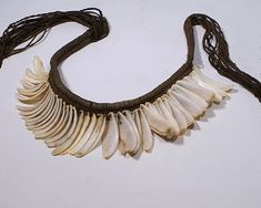 It is very rare to find a shell necklace with original stringing intact.   This necklace is an excellent example of the Nasca culture's ingenuity in using the local marine resources.   Each of the 55 shells is intricately tied to an elaborately knotted foundation cord made of alpaca wool. The shell appears to be derived from a mussel or razor clam.  A similar necklace is in the collection of the American Museum of Natural History.  Created by the Nasca culture on the South coast of Peru, circa AD 400 - 800. Peruvian Textiles, American Museum Of Natural History, Museum Of Natural History, Shell Necklace, Shell Jewelry, Shell Necklaces, Alpaca Wool, Natural History, Beaded Necklaces