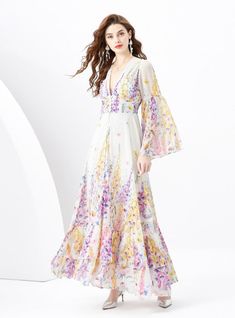 "Blossoming with the vibrant vitality of spring, this enchanting dress encapsulates the essence of a serene garden in full bloom. It’s a poetic sartorial choice for the romantic at heart, featuring a soft, flowing fabric adorned with delicate floral prints in a symphony of lilac, yellow, and pink hues. The deep V-neckline exudes a hint of allure, balanced by the full-length bishop sleeves that add a touch of bohemian elegance. Each tier of the skirt cascades gently to the ground, creating a silh Enchanting Dress, Chiffon Ruffle Dress, Medium Skirt, Gallery Opening, Serene Garden, Afternoon Wedding, Sleeveless Dresses Casual, Spring Breeze, Flowing Fabric