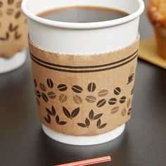 a cup of coffee sitting on top of a table