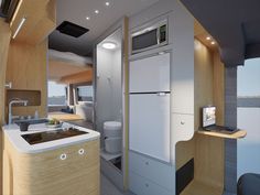 the interior of an rv with wood paneling and white appliances