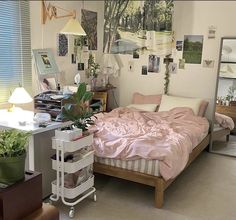 a bed room with a neatly made bed and lots of pictures on the wall above it