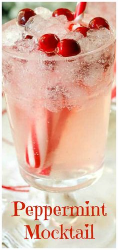 a close up of a drink in a glass with ice and cherries