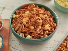 a bowl filled with cheetos next to bowls of macaroni and cheese