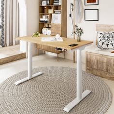 a living area with a rug, table and bookshelf on the wall next to it