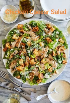 chicken caesar salad on a plate with dressing