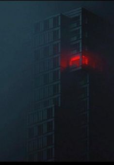 a tall building in the fog with red light on it's windows and side