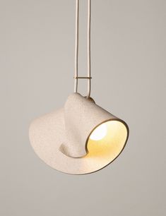 a white light hanging from a ceiling with a cord attached to the side of it