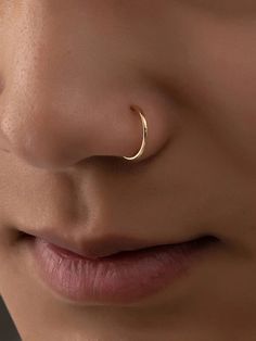 a woman's nose with a gold nose ring