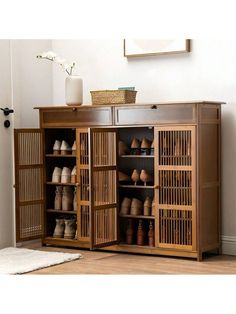 a wooden cabinet with many pairs of shoes on it and a basket next to it