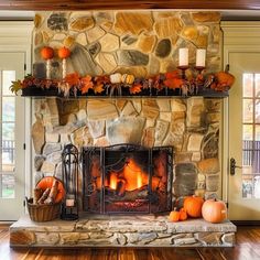 the fireplace is decorated with pumpkins and candles