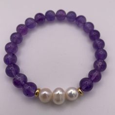 DESCRIPTION: Amethyst and pearl bracelet, combining the subtle charm of amethyst with the classic elegance of pearls. A versatile and sophisticated accessory for any occasion. FEATURES: Genuine Stones & Pearls. 10mm beads. Filled gold 18k. Elegant Purple Pearl Bracelet With Round Beads, Elegant Lavender Beaded Bracelets, Classic Amethyst Bracelets In Purple, Elegant Purple Rondelle Beaded Bracelets, Classic Amethyst Purple Bracelets, Classic Purple Amethyst Bracelets, Elegant Round Amethyst Beaded Bracelets, Elegant Amethyst Beaded Bracelets, Elegant Amethyst Rondelle Beaded Bracelets