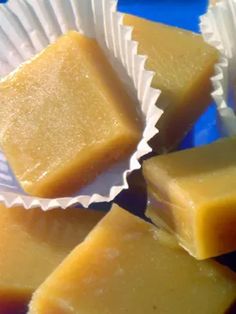 several pieces of yellow soap sitting on top of each other in paper cups with white wrappers