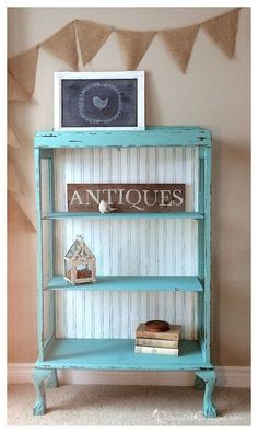 an antique shelf with books and pictures on it