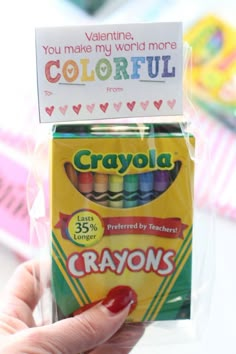 someone holding up a box of crayons for valentine's day or birthday