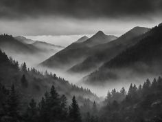 black and white photograph of fog in the mountains