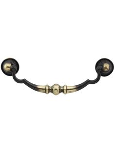 an antique brass and black door handle on a white background, with two knobs in the middle