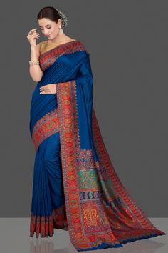 Shop beautiful indigo blue silk saree online in USA with red Kani embroidery border. Get ready for festive occasions and weddings in tasteful designer sarees, Banarasi sarees, handwoven sarees from Pure Elegance Indian clothing store in USA.-full view Blue Kalamkari Pre-draped Saree For Diwali, Blue Bollywood Tussar Silk Saree, Blue Katan Silk Dupatta With Kalamkari Print, Blue Katan Silk Saree With Kalamkari Print, Blue Silk Traditional Wear With Printed Border, Blue Bollywood Pre-draped Saree In Tussar Silk, Blue Bollywood Pre-draped Tussar Silk Saree, Blue Dola Silk Saree For Navratri, Blue Dola Silk Saree With Traditional Drape