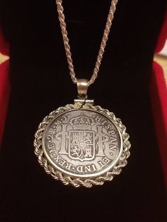 "Neat Antique Rare well preserved 1777 Spanish 2 Reale Colonial Treasure .896 Silver Coin Pendant set on an Italian Sterling Silver Rope Chain. W COA & Box. This coin was minted in 1777 this is a very rare and well preserved classic original Spanish coin The authentic Spanish 1777 2 Reale coin is set into a handsome sterling silver bezel pendant with well-detailed silver rope edging Our Italian made sterling silver rope chain has a 2 mm diameter and is available from 16\" to 30\" The outside Silver Coin Pendant Jewelry For Anniversary, Anniversary Silver Coin Pendant Jewelry, Silver Coin-shaped Engraved Necklace, Silver Coin-shaped Engraved Necklaces, Silver Engraved Round Coin Necklace, Antique Silver Coin Pendant Jewelry, Antique Silver Jewelry With Coin Pendant, Silver Engraved Pendant Coin Necklace, Silver Engraved Coin Pendant Necklace