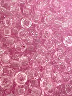 pink plastic beads are shown in close up