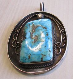 "Sterling silver and turquoise pendant. Southwest Native American style. The pendant is 2 1/4\" tall x 2\" wide. The bail adds 1/2\" to the height. Pretty stone with lots of matrix. The back of the pendant has three solder lines on it which makes me think this may have been a cuff bracelet at one time. Good condition with natural patina. Stamped JM. Shipped by US first class mail. PWS-4" Collectible Blue Turquoise Necklace With Large Pendant, Blue Turquoise Necklace With Large Pendant, Turquoise Pendant Necklace With Patina, Collectible Large Pendant Turquoise Necklace, Native American Style, Native American Fashion, Jewelry Antique, Tucson Az, Turquoise Pendant