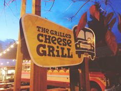 the grilled cheese grill sign is lit up at night