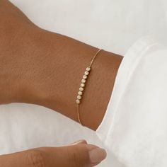 The Maelie Bracelet features a row of 9 bezel-set diamonds on a dainty 14k yellow gold chain. 

Versatile and elegant, this bracelet will elevate any look.


9 lab grown diamonds, each with a width of 2mm 

Total carat weight: 0.27 

14k yellow gold 


Bracelet can be worn between 5.75” and 7” (fitting wrists with circumference ~5.25” to 6.75”) Cute Gold Bracelets Simple, Cute Gold Bracelets, Dainty Bracelets Gold, Dubai Gold Bangles, Everyday Bracelets, Bracelets Minimalist, Plain Gold Bangles, Ring Redesign, Delicate Gold Bracelet