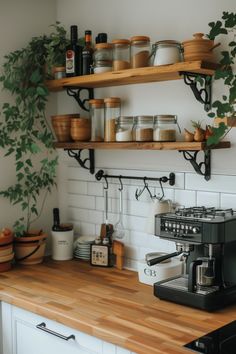 a kitchen counter with pots and pans on shelves above the coffee maker, along with other cooking utensils