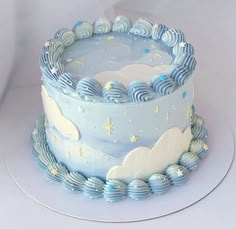 a blue cake with clouds and stars on it