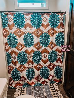 a bathroom with a colorful shower curtain and toilet