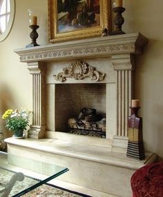 a living room with a fire place and painting on the wall above it's mantle