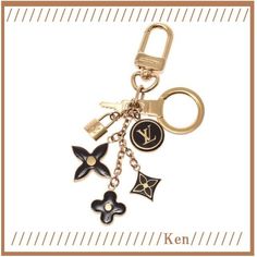 louis vuitton keychain with charms and keys attached to the front of it