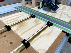 a table that has some pieces of wood on it with green tape around the edge